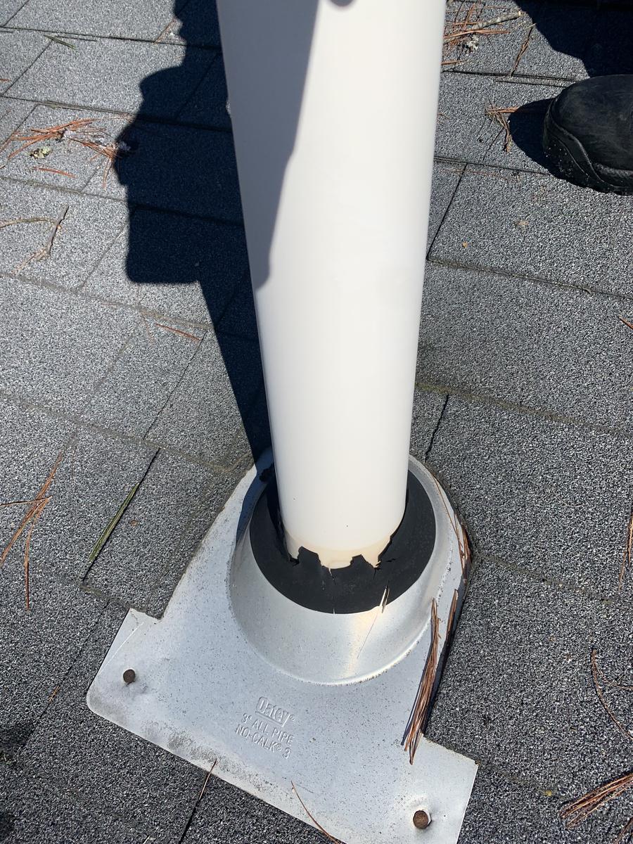 Cracked and split plumbing vent pipe boot on a roof causing a leak, before repair by David Deschaine Roofing