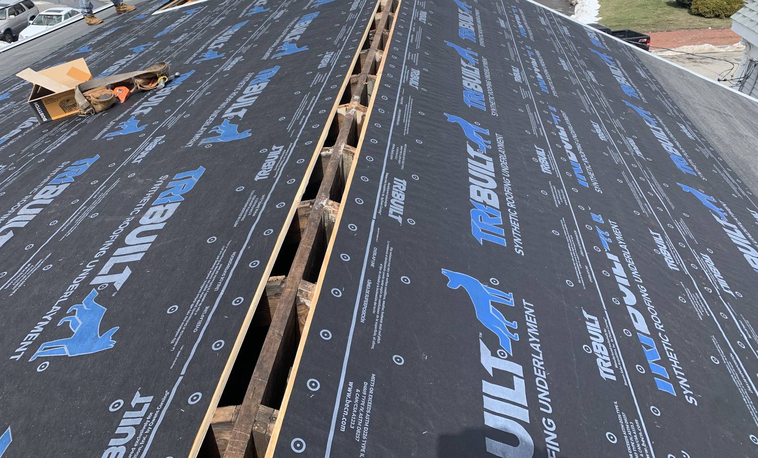 New roof in progress with synthetic roofing underlayment installed over the roof deck by David Deschaine Roofing